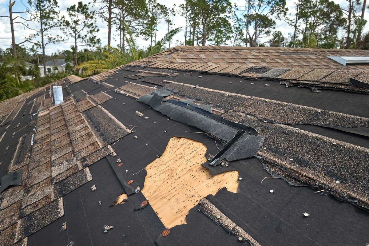 Roofer using chalk to circle hail strikes during a test square inspection