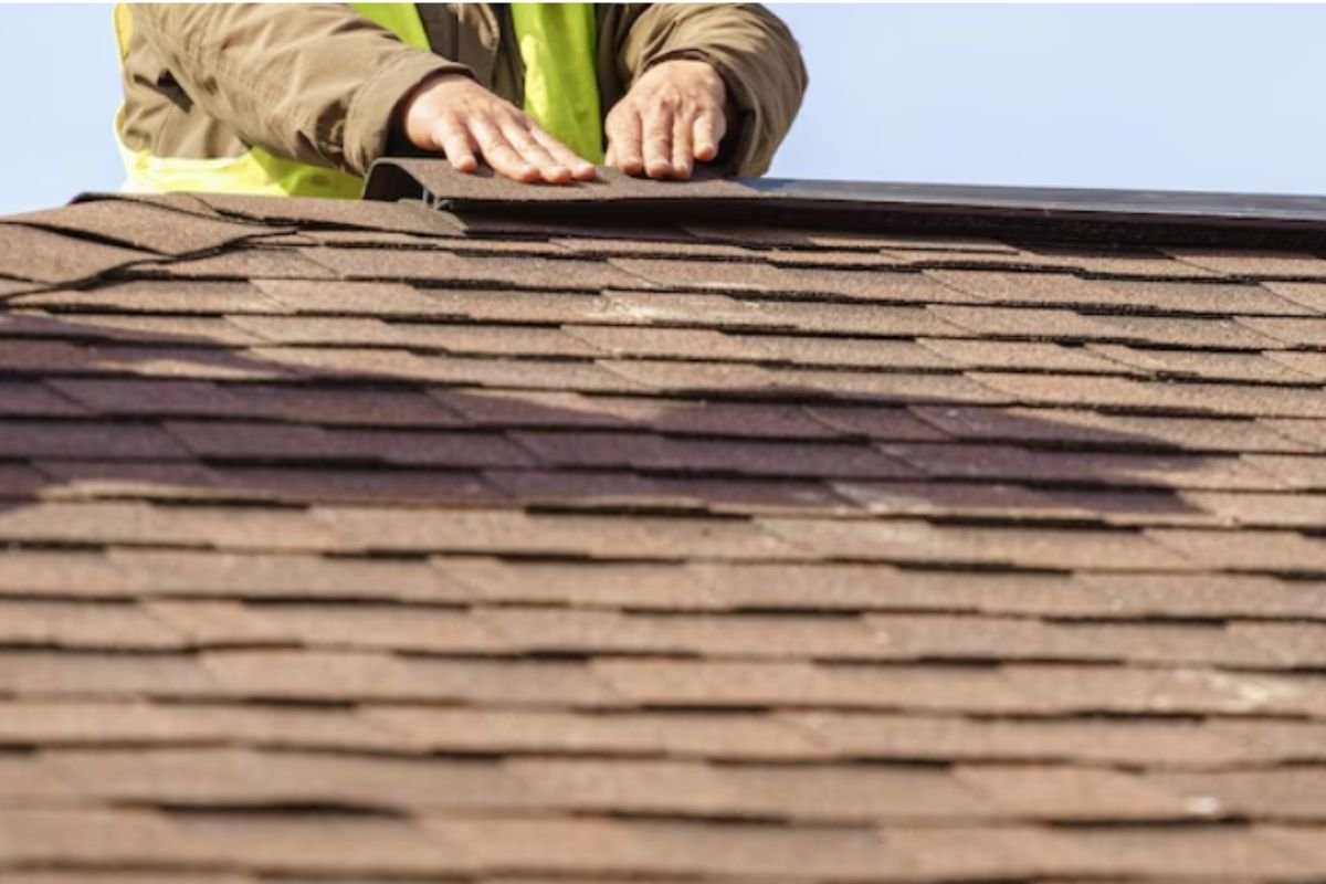 Crew tearing off old shingles for full hail replacement on Waukesha home